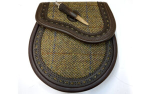 Dark brown etched edge sporran with harris tweed inlayed on flap and front of sporran. Made in Scotland. Scottish Treasures