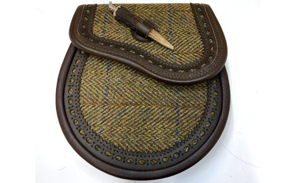Brown leather with stag horn closure, harris tweed inlay on flap and front of sporran. Suede lining inside. Made in Scotland. Scottish Treasures